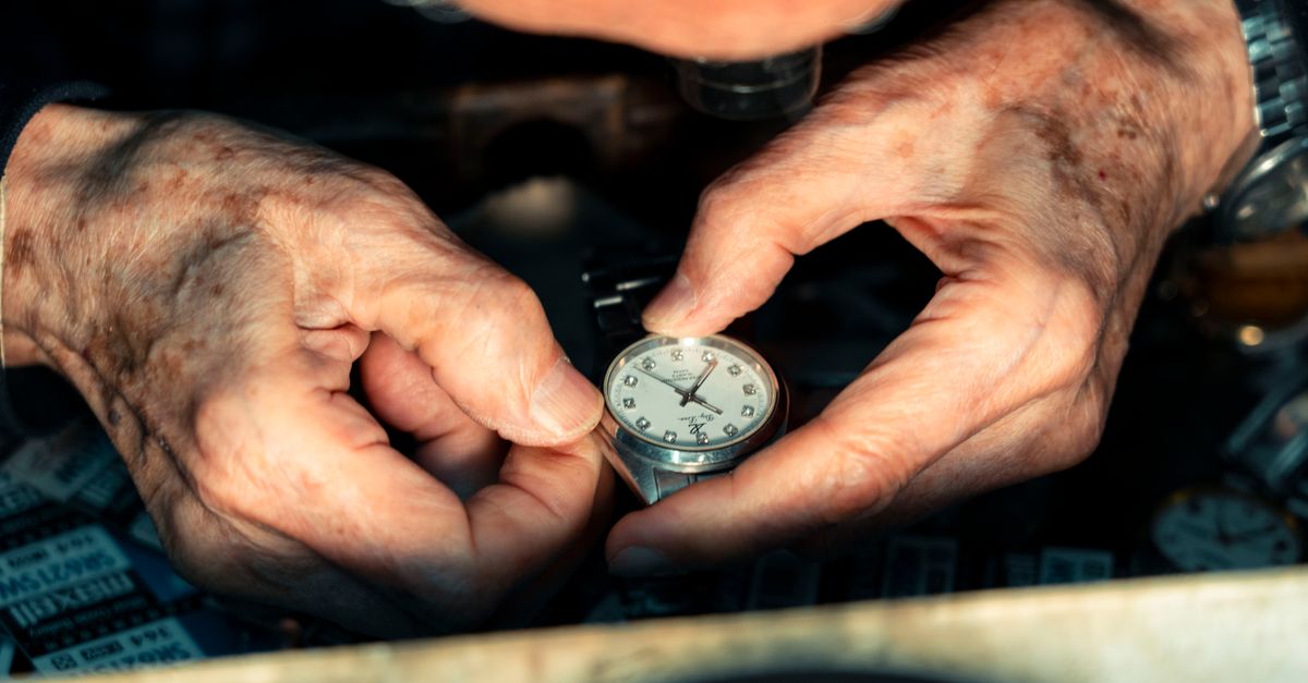 Detailed shot of a watchmaker's hands skillfully repairing a wristwatch under magnification.